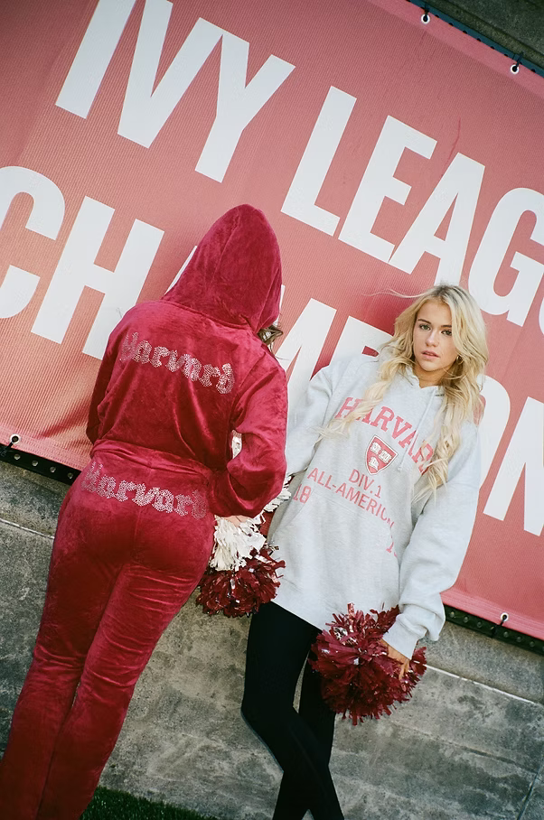 Ava in Harvard gear by an Ivy League Champions banner